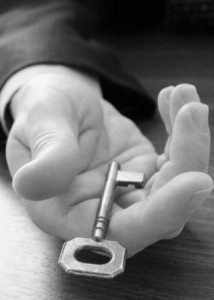Hand holding out a key